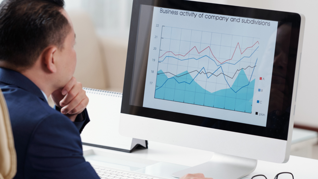 A man sitting facing his laptop while looking for the SEO Analytics